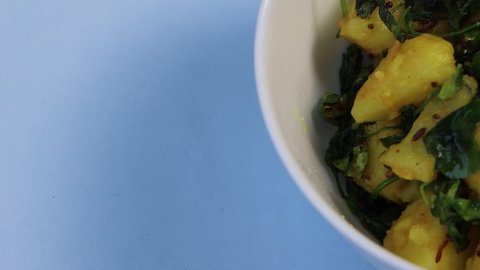 Aloo Methi in white bowl, indian cuisine dish with Potato, Fenugreek and Spices, Indian Food