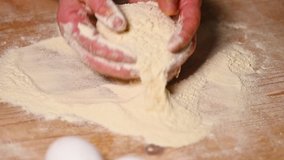 Slow motion video of a woman making some Fettuccine, a homemade pasta from flour and fresh eggs. 