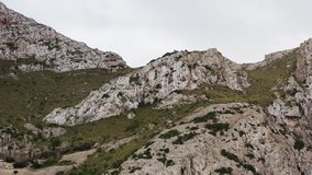 Mountain landscape Mallorca island Spain dron 4K video. Aerial view of mountain ranges with rocks, peaks on which grow shrubs and trees.