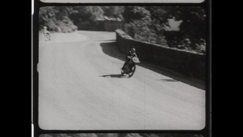 1947 Douglas, Isle of Man. Man Wrecks Motorcycle on Snaefell Mountain course during Isle of Man TT or Tourist Trophy Race. 4K Overscan of Vintage Archival Film Print