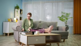 work at home, young female employee in jacket and pajama pants is works remotely using modern technologies and applications on computer talks with customer via video link while man in headphones - Powered by Shutterstock - Get 15% off with code: PIKWIZARD15