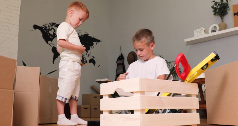 two boys play with building tools. two brothers.