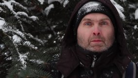  A frozen man in a brown jacket with a black hat and gloves tosses snow. - Powered by Shutterstock - Get 15% off with code: PIKWIZARD15