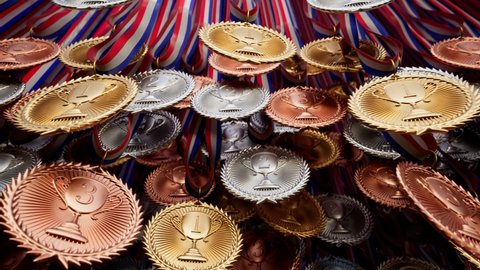 Plenty of gold, silver and brown medals for winners. Set of prizes for champions. Shiny sports awards with ribbons. Symbol of winning competition, success, victory, triumph, achievement. Trophies.