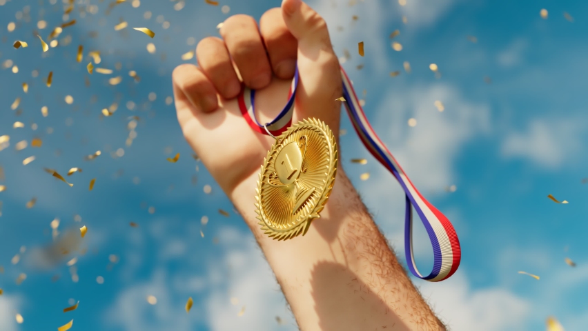 Rising hand holding a shiny gold medal. Top winner with first prize. Sports award for a champion. Winning a competition. Success, victory, triumph. Moment of glory. The greatest achievement. Confetti. | Shutterstock HD Video #1066662868