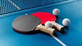 Camera moving around the table tennis set. Ping pong balls, paddles, and a net. Ping pong accessories ready to play. Professional sports equipment for table tennis. In the middle of the competition. - Powered by Shutterstock - Get 15% off with code: PIKWIZARD15