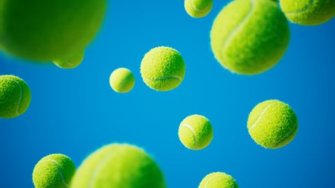 Loopable animation of falling tennis balls. Slow-motion shot. Blue background.Endless supply of tennis balls. Rental of sports equipment for tennis. Presenting professional sports accessories. 4K HD