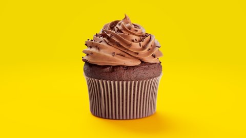 Seamless loop animation of a delicious cupcake with chocolate cream and sweet sprinkles. Spinning around homemade tasty brown muffin on yellow background. Yummy dessert decorated with dark chocolate.
