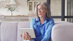 Senior old senior woman grandmother holding digital tablet video conference calling talking with doctor or family during social distance virtual visit in online chat meeting at home. - Powered by Shutterstock - Get 15% off with code: PIKWIZARD15