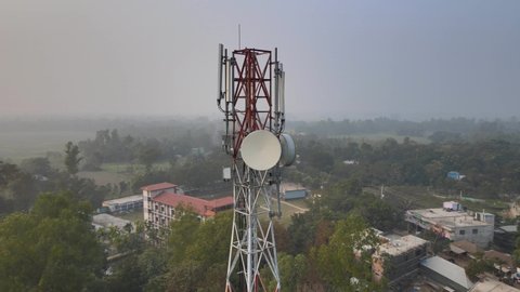 Mobile tower in Bangladesh village aerial drone shot. Bangladesh 4g mobile tower. 4g cellular tower in the remote village of Bangladesh. 