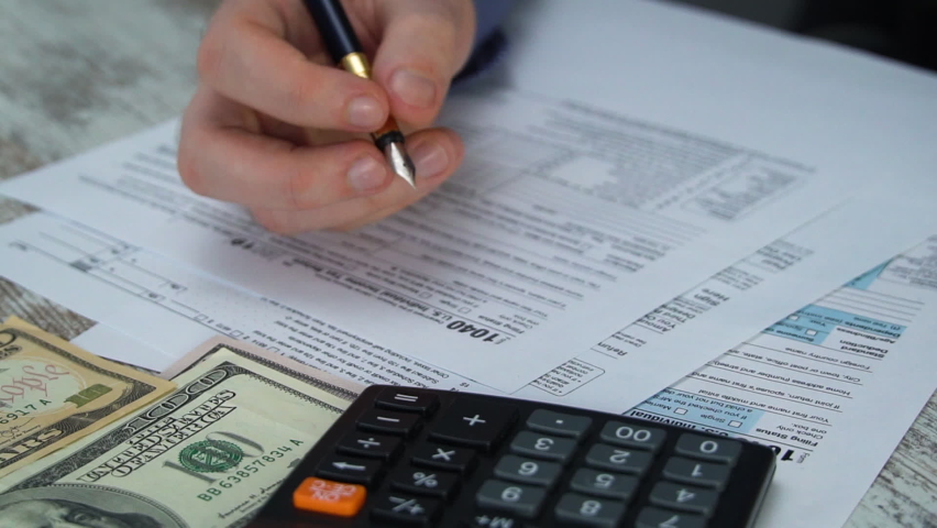 Man filling US tax form. tax form us business income office hand fill concept. Tax Return Form 1040 Royalty-Free Stock Footage #1066668667