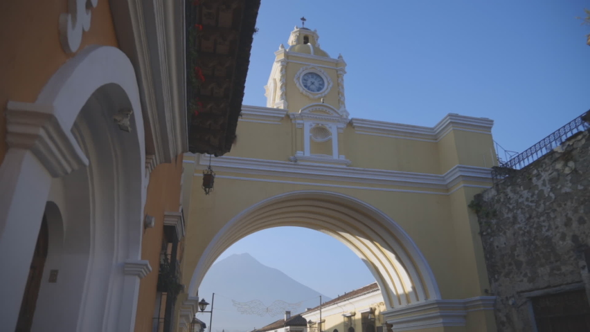 Arch of Santa Catalina in Antigua Guatemala with the blue sky in the background early in the morning - emblematic square in Antigua Guatemala with the water volcano in the background  | Shutterstock HD Video #1066671967