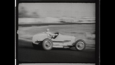 1940s Zürich, Switzerland. Stunt Drivers Race around a Dirt Track in Alfa Romeo Race cars. 4K Overscan of Vintage Archival  16mm Film Print