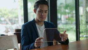 Handheld shot with young smart man use mock-up tablet with invisible hologram virtual screen future technology in coffee shop, blank space to insert holographic on screen, High technology concept - Powered by Shutterstock - Get 15% off with code: PIKWIZARD15