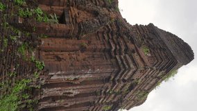 Vertical video. Handheld shot of ruins in the My Son Sanctuary, remains of an ancient Cham civilization in Vietnam. Tourist destination in the city of Danang. Travel to Vietnam concept