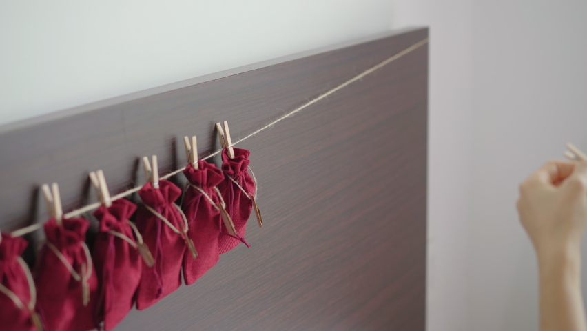 A young woman prepares an advent calendar for her child