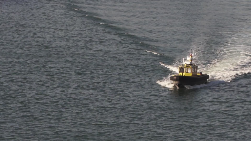 Marine Policing Unit boat cruising the Honolulu Canal waters at full speed, in Oahu, Hawaii - Long close up shot