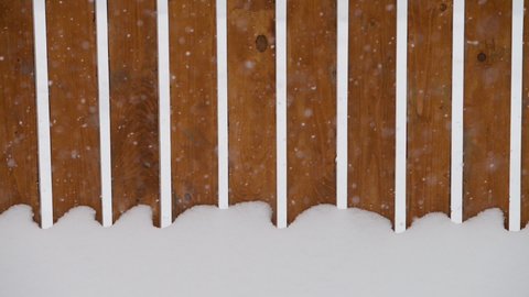 a wooden fence in the snow