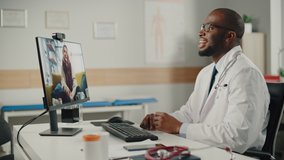 Doctor's Online Medical Consultation: African American Physician Making a Conference Video Call with a Patient on a Desktop Computer. Health Care Professional Giving Advice, Explaining Test Results.