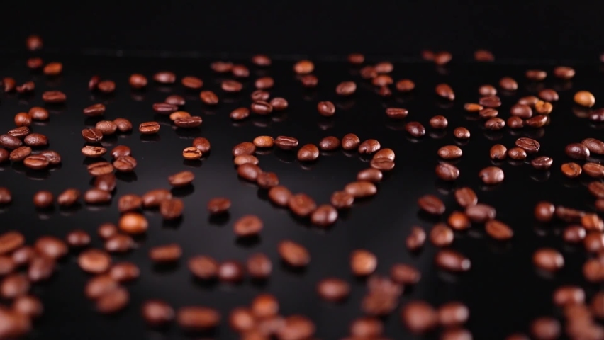 Heart shape coffee beans on black background