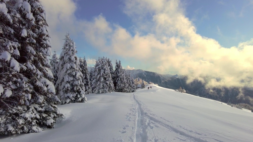 Snowy alpine winter landscape with ski trail