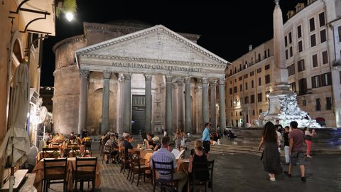 Rome, Italy - Circa September, 2020: People dining outdoors with view to Pantheon at Piazza della Rotonda square by night