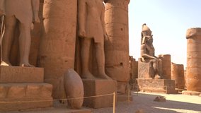 Sculptures of pharaohs inside the Luxor Temple and the drawings on the Egyptian columns in the city of Luxor along the Nile. Egypt, 4k video
