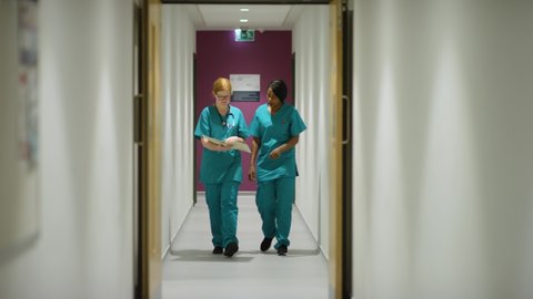 Medical Staff Walking Through Hospital