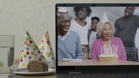 Sliding Medium Shot of Laptop Screen with Family Singing Happy Birthday On Video Call