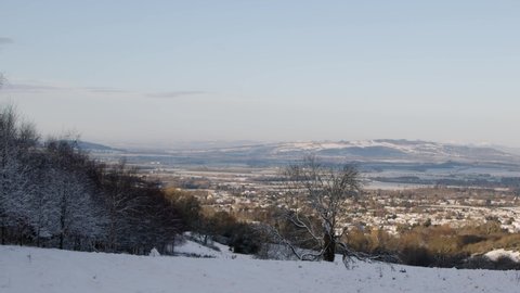 Panning Shot Overlooking Snow Covered Hills In English Countryside