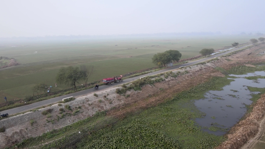 Bangladesh Village Road aerial drone shot. Foggy Winter moring in Bangladesh village.