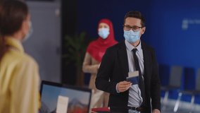 Flight attendant woman in medical mask servicing businessman young passenger client checking ID information and visa check-in registration. - Powered by Shutterstock - Get 15% off with code: PIKWIZARD15