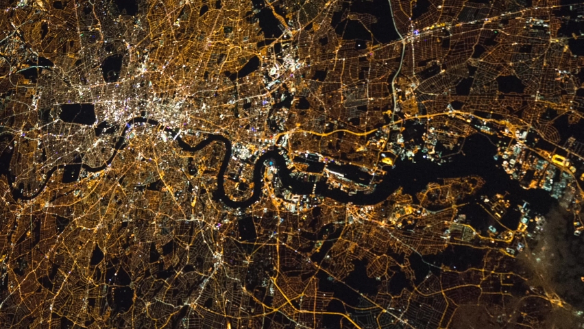 London city from space during night time from a satellite. Contains public domain image by NASA. Royalty-Free Stock Footage #1066734670