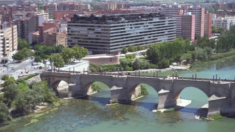 Aerial view of Zaragoza cityscape and stone bridge over Ebro river fro