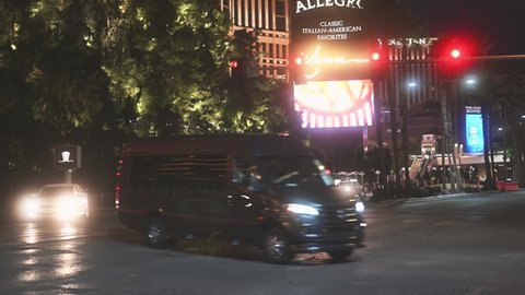 Las Vegas, Nevada - February 1, 2021: cars driving and making left turns at Las Vegas Blvd at night.