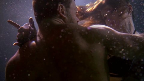 love and passion of girlfriend and boyfriend underwater, lovers are floating in depth of pool