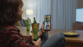 Young happy attractive asia female enjoy relax night party event online celebration festive with friends at home clinking beer cheers with glass and bottle toasting drinking via online video call.