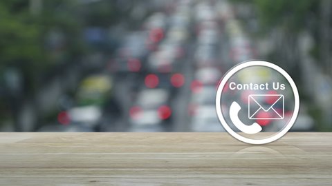 Telephone and mail flat icon button on wooden table over blur of rush hour with cars and road in city, Business contact us concept