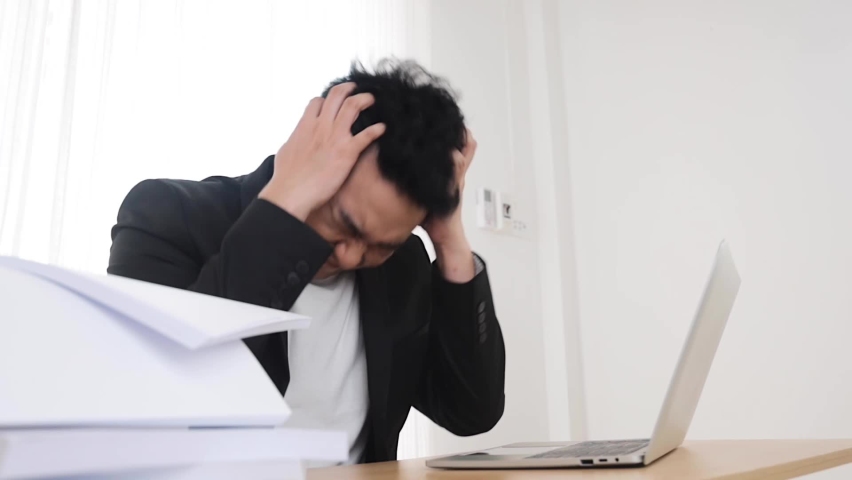 Worried businessman working at office,Tried business holding his head in. Hands. | Shutterstock HD Video #1066763896