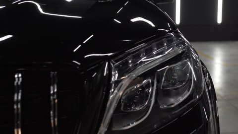 Black mirror premium car in the detaling studio after polishing.