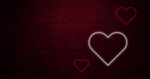 Animation of red and white neon hearts flashing on dark brick wall. valentines day, love and romance concept, digitally generated video.