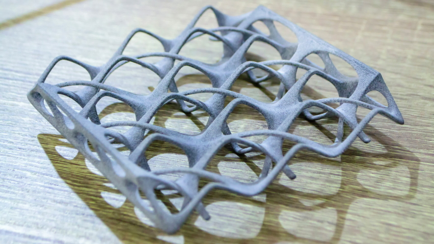 Object printed on powder 3D printer from polyamide powder close-up. Three-dimensional model from thermoplastic gray color. Rapid prototyping, printing products. Progressive modern additive technology