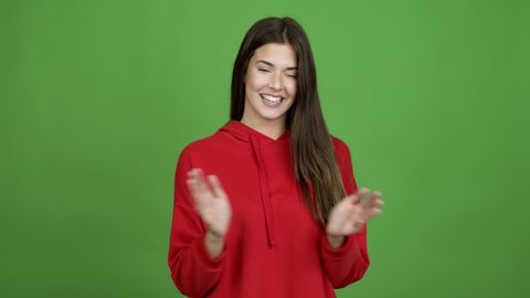Teenager Brazilian girl applauding after presentation in a conference over isolated background. Green screen chroma key video