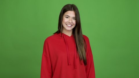 Teenager Brazilian girl saluting with hand with happy expression over isolated background. Green screen chroma key video