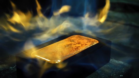Golden Bar Production. Beautiful Shot of Ingot in Fire Flame. Manufacture. Blow torch flame. Factory Scene. Hot Liquid Gold Solidification. Non ferrous industrial Factory. Close Up