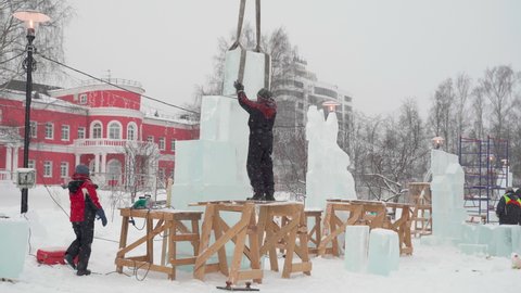 
Russia, Petrozavodsk. - February 4, 2021. Preparations for the international winter festival "Hyperborea 2021". People work with ice. They make ice sculptures.