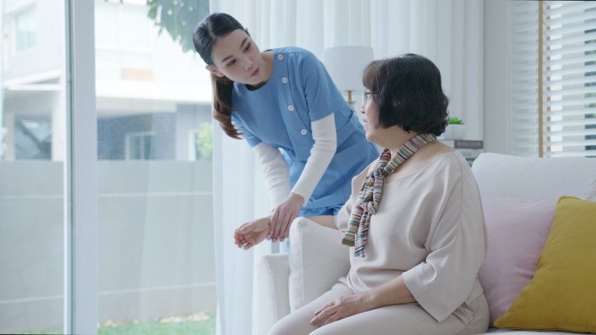 Young senior asia citizen female with scrubs nurse physiotherapy worker at home in rehabilitation therapy service for aging parents. Massage for older care, ache pain joints exercise in old people. | Shutterstock HD Video #1066779475
