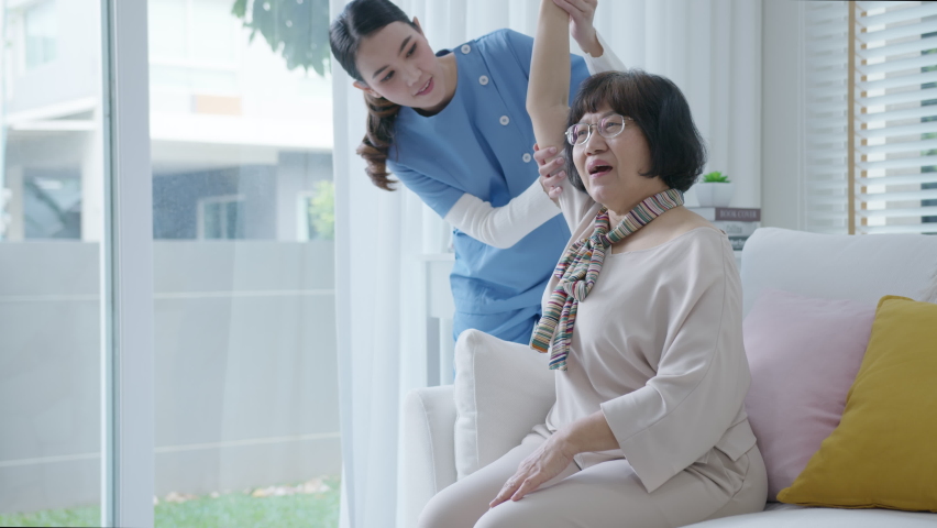 Young senior asia citizen female with scrubs nurse physiotherapy worker at home in rehabilitation therapy service for aging parents. Massage for older care, ache pain joints exercise in old people. | Shutterstock HD Video #1066779475