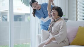 Young senior asia citizen female with scrubs nurse physiotherapy worker at home in rehabilitation therapy service for aging parents. Massage for older care, ache pain joints exercise in old people. - Powered by Shutterstock - Get 15% off with code: PIKWIZARD15