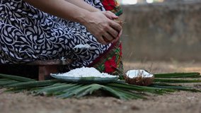 Woman hand grating fresh raw coconut cut open in half 4K slow motion video , footage of Indian Kitchen , Kerala India. organic coconut farm, fresh grated for making coconut milk , oil